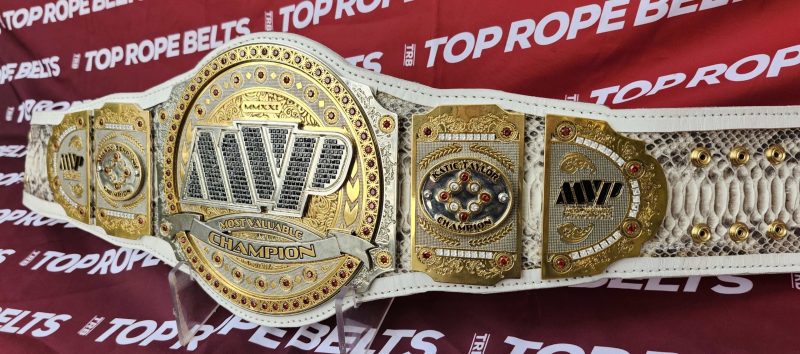 MVP women's championship belt showing the center plate and right side plates with red gemstones